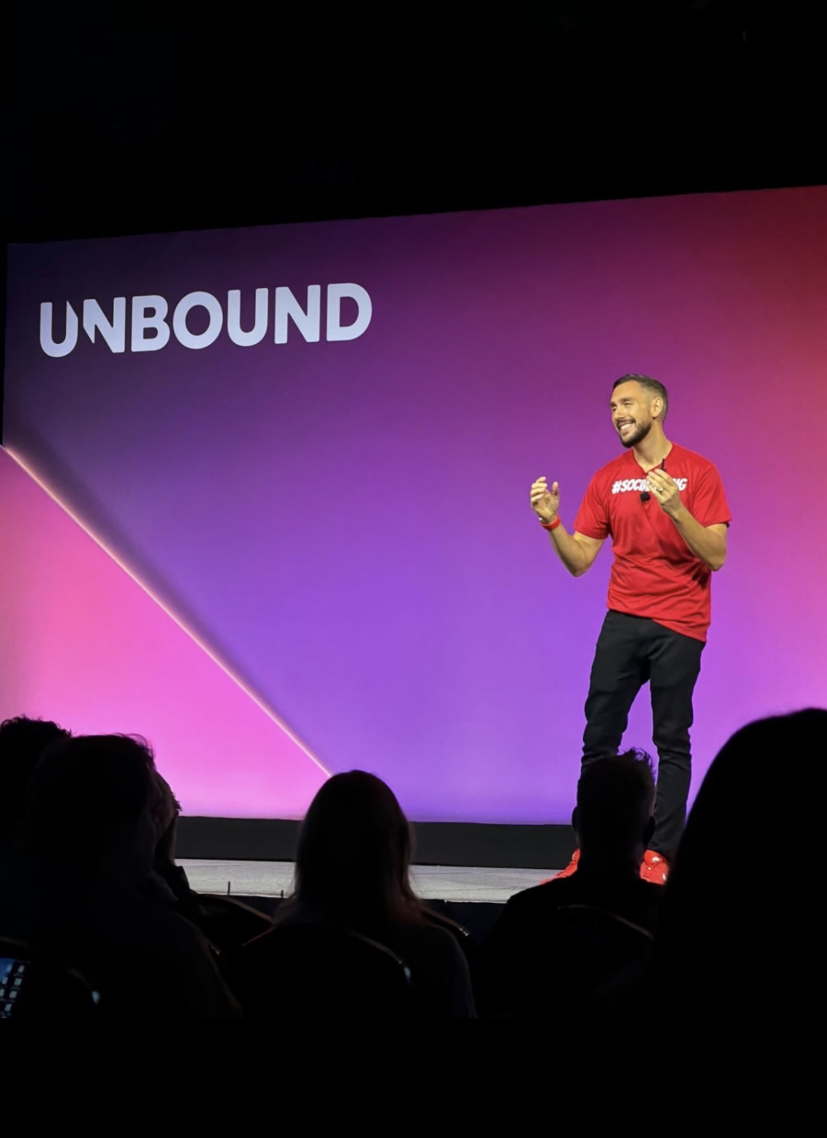 Daniel Disney on stage at a sales conference